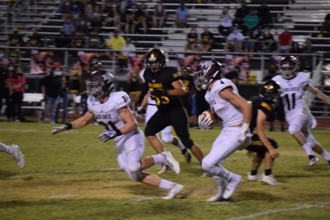A DIFFERENT VIBE: During a 49-21 victory against Barry Goldwater, senior tight end Anthony Pescatore (31) blocks for the kick returner. “The vibe is going to be totally different since there is no Wolfden--that huge support system is gone,” Pescatore said. The Wolves leaped to a fast 3-0 start, outscoring opponents 97-38--but the team was forced to postpone its Homecoming game Oct. 23 against Casa Grande after a player from Barry Goldwater tested positive for coronavirus.