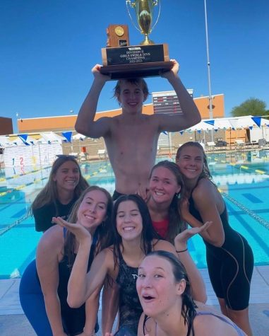 STATE CHAMPS--Olivia Prelog (12), Carly Johnson (11), Juliette Daigneault (9), Molly Wert (12), Marley Ransick (11), Kylie Ney (12), and Cameron Kelly (12) celebrate DMs mens and womens swim teams state titles.