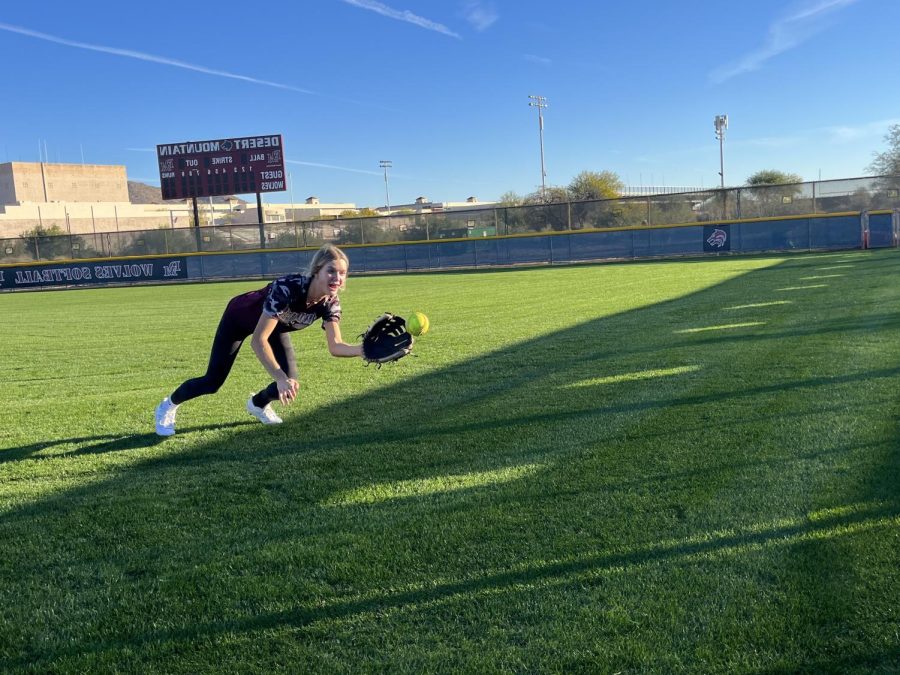 GET THE BALL ROLLIN: Sophomore McKinsey Beyer dives for a ball in the outfield. Showing how she is willing to give up her body for the play. I love pre-season training; Its always is refreshing to see the same girls from last year. We are just one big family, says Beyer.
