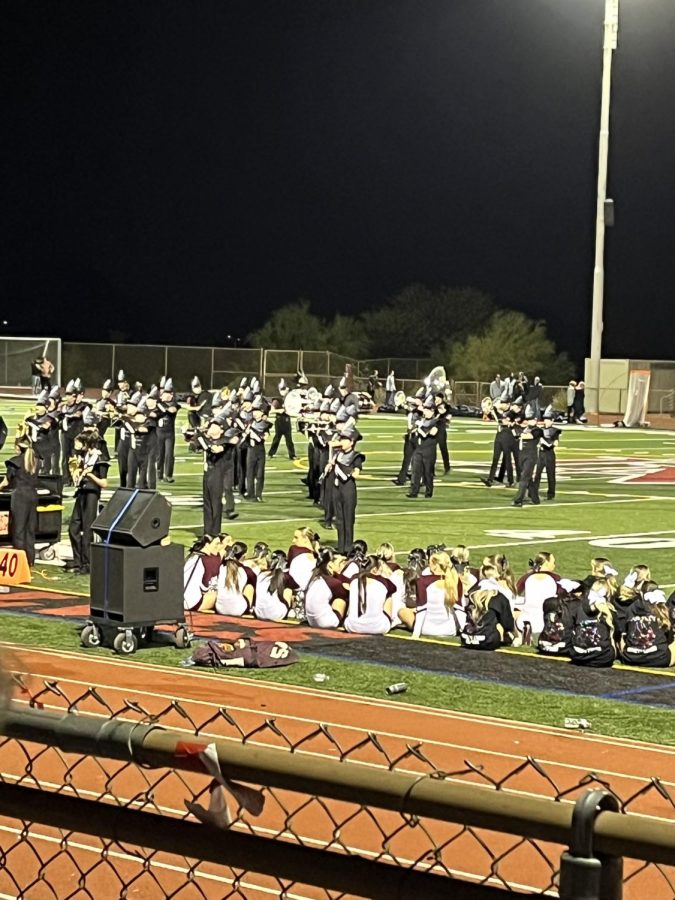 ALWAYS PROUD OF THESE STUDENTS: The DMHS marching band performs in DMs semi-finals game against Higley, putting on a show during halftime. “The marching band is an awesome, welcoming atmosphere throughout the football season, said band teacher Mr. Hummel, adding he is always proud of these students.” The marching band has always rested near the top when coming to state competitions, especially thanks to Mr. Hummels positive attitude and way of teaching.
