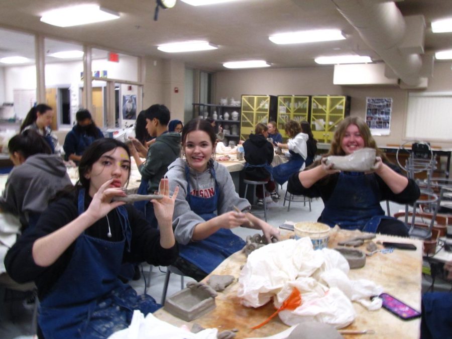 CREATIVE WITH CLAY: Nicole Tavolini (12), Isabel Stratton (11), and Ava Jazwin (11) work on their ceramics final, which is to create a non-utilitarian abstract sculpture using techniques learned during the semester. It is really nice coming to first period in the morning and to be able to create things out of clay, says Tavolini. It is stress relief for me. Students in Sculpture and Design work with clay and glaze daily in a hands-on class environment. Although their art has to meet certain criteria, students are otherwise able to have plenty of creative freedom. 
